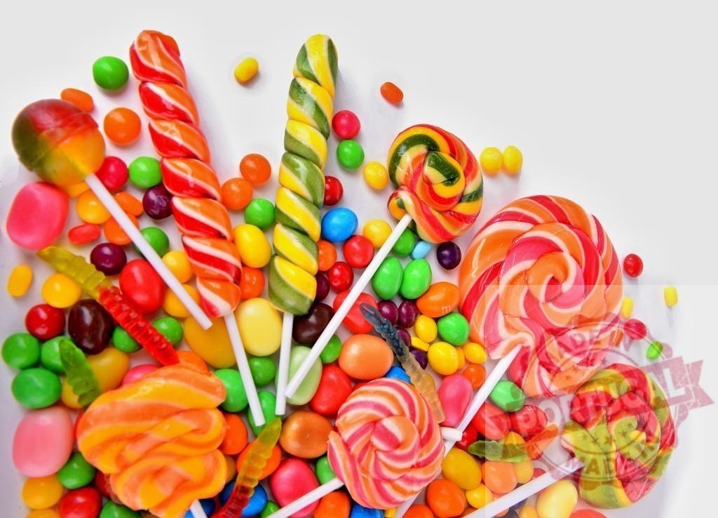 Colorful lollipops and candies creating a sweet background | Assortment of vibrant lollipops, hard candies, and gummy sweets filling a white surface - Realized with Pictrs.com