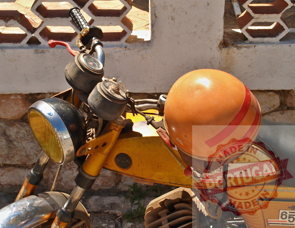 Orange helmet resting on vintage yellow moped | Orange helmet with red stripes resting on a vintage yellow moped parked against a wall - Realized with Pictrs.com