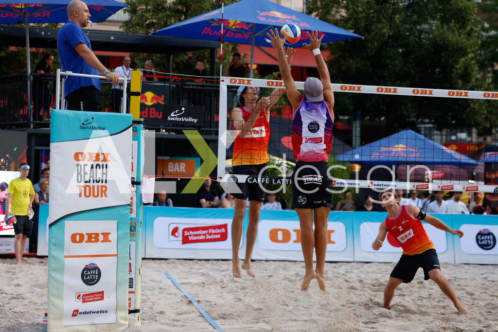 Obi BeachTour 2026 - Basel | BASEL, SWITZERLAND - JULY 17: YVES HAUSSENER (SUI) attack / spike against GAÉTAN JAUFFRET (SUI) block during the Obi BeachTour 2026 match between HAGENBUCH / HAUSSENER (SUI) and BORTOLUZZI / JAUFFRET (SUI) at Barfüsserplatz on July 17, 2026 in Basel, Switzerland. - Realisiert mit Pictrs.com