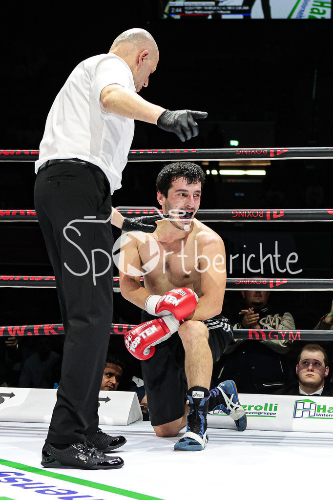 Profi - Box - Gala / Main Event | Nika GVAJAVA (schwarze Hose) in seinem Kampf gegen Kushtrim TAHIRUKAJ (rot schwarze Hose) wird vom Ringrichter Guenter ECKER angezaehlt