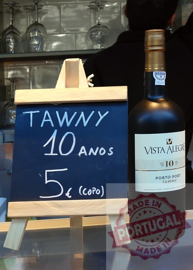 Bar offering Tawny 10 aos Porto Vista Alegre bottle and price | Bar counter displaying Tawny 10 aos Porto Vista Alegre bottle with chalkboard price - Realized with Pictrs.com