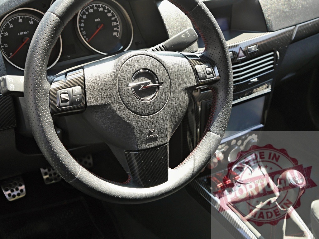 Opel car interior with carbon fiber tuning details | Opel car dashboard showcasing a custom carbon fiber steering wheel and gear shift - Realisiert mit Pictrs.com