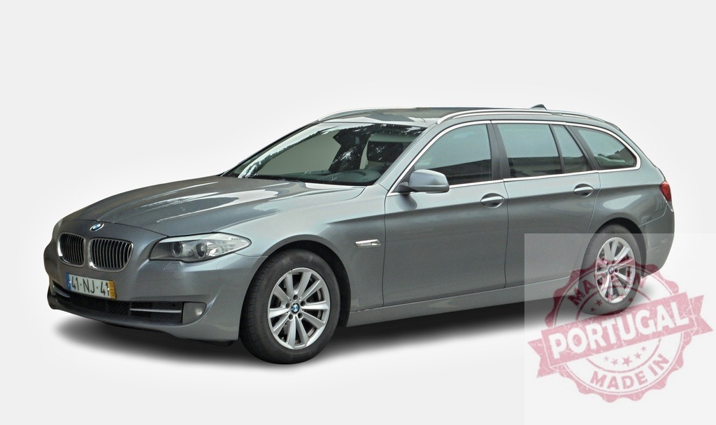 BMW 5 series touring car posing in studio on white background | Modern gray BMW 5 series touring car posing in a studio setting with a white background - Realisiert mit Pictrs.com