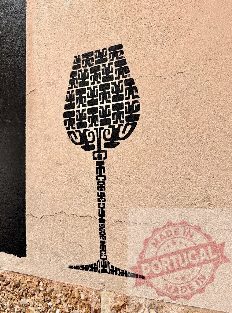 Wine glass graffiti on building wall urban art | Wine glass shape created from abstract black patterns and text painted on a textured wall - Realized with Pictrs.com