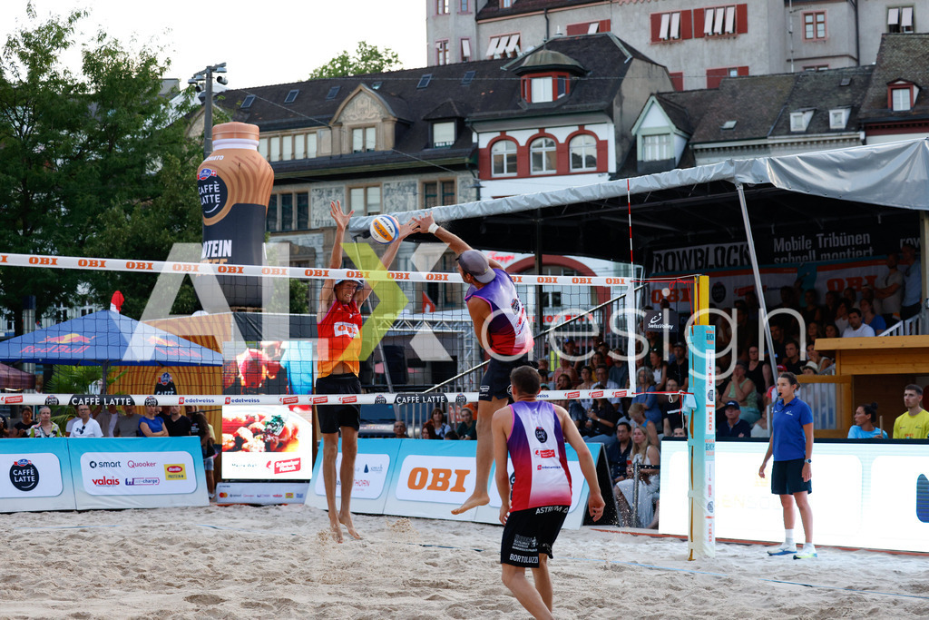 Obi BeachTour 2026 - Basel | BASEL, SWITZERLAND - JULY 17: GAÉTAN JAUFFRET (SUI) attack / spike against SIMON HAGENBUCH (SUI) block during the Obi BeachTour 2026 match between HAGENBUCH / HAUSSENER (SUI) and BORTOLUZZI / JAUFFRET (SUI) at Barfüsserplatz on July 17, 2026 in Basel, Switzerland. - Realisiert mit Pictrs.com