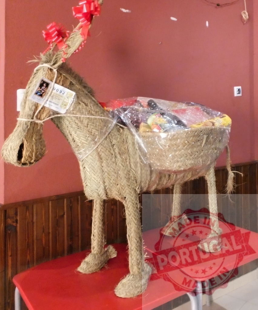 Esparto donkey figure carrying a Christmas gift basket | Esparto donkey figure holding a basket with raffle tickets and festive gifts - Realized with Pictrs.com