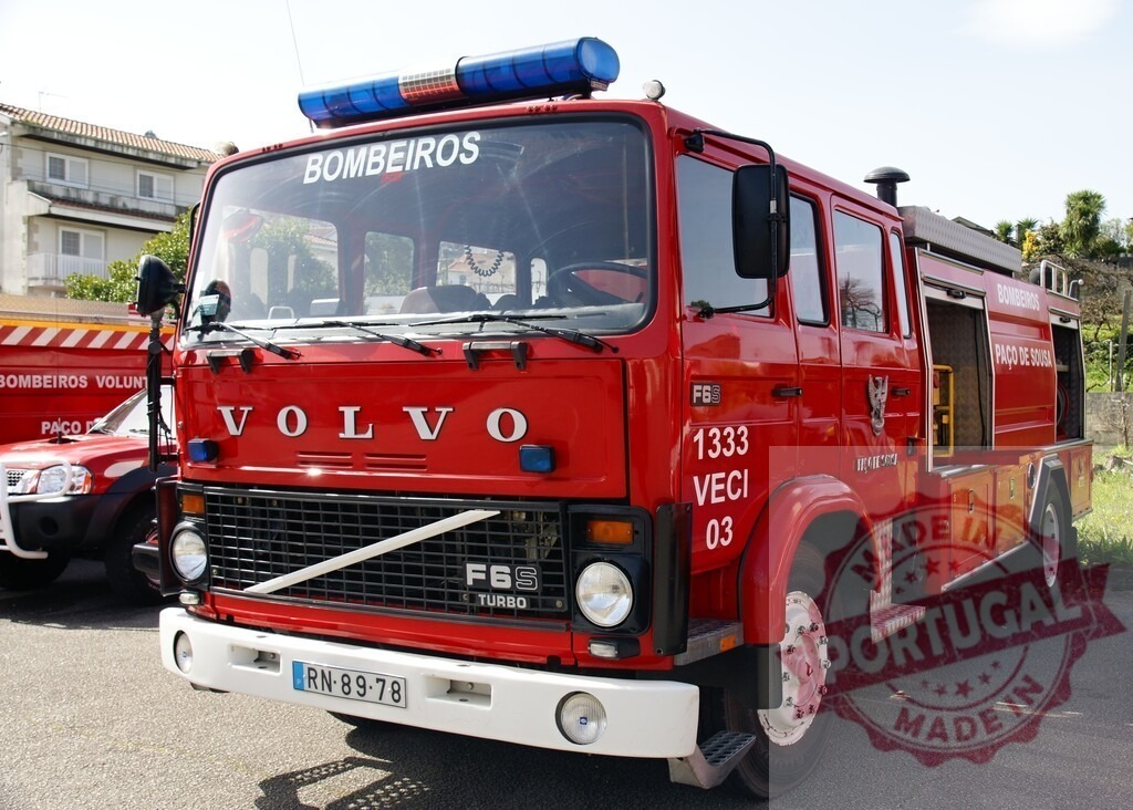 Red Volvo F66 fire truck at Bombeiros station | Red Volvo F66 fire engine parked outdoors, ready for emergency response - Realized with Pictrs.com