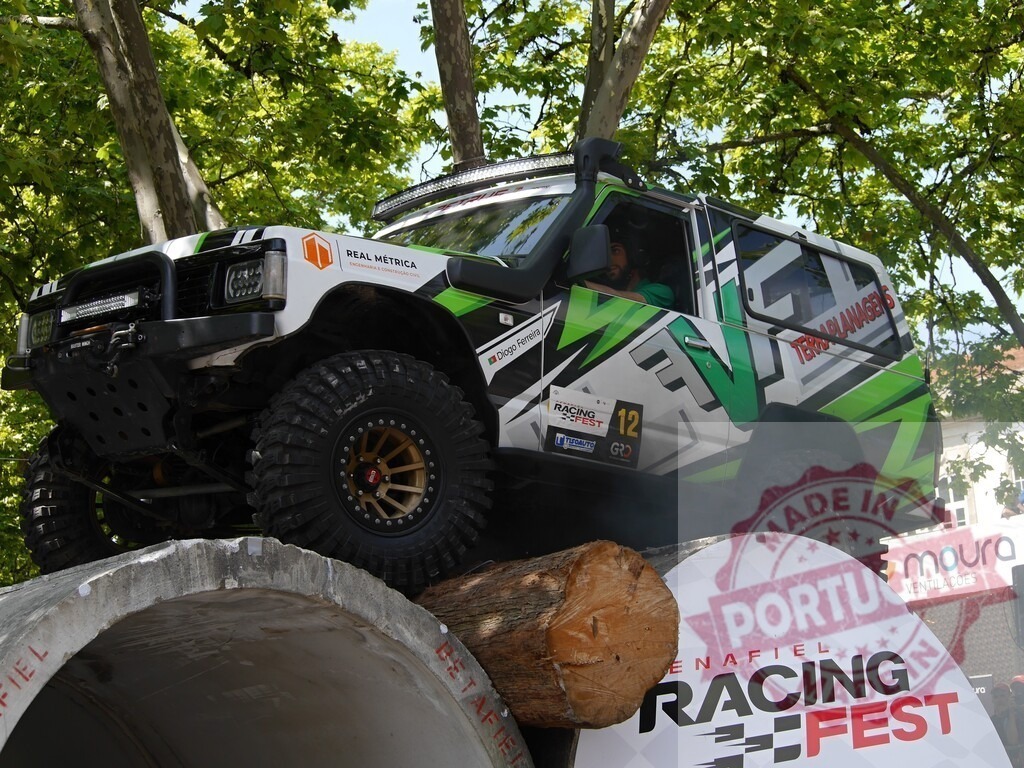 Tuned nissan patrol climbing obstacles at racing fest | Professional pilot driving tuned nissan patrol climbing over concrete pipe and wood log at racing fest - Realized with Pictrs.com