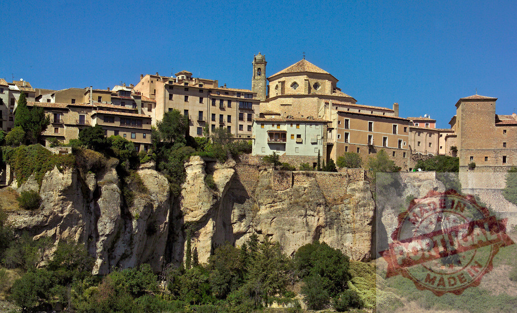 Cuenca hanging houses built on high cliff edge. Cuenca - Spain | Cuenca historic city showing traditional architecture on rocks under a clear blue sky - Realized with Pictrs.com