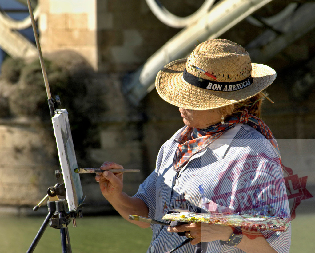 Woman artist painting outdoors wearing straw hat | Artist painting on an easel with a palette, expressing creativity outdoors - Realized with Pictrs.com