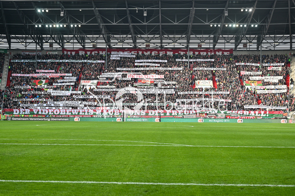 FC Augsburg - 1. FC Heidenheim | AUGSBURG, GERMANY - 15. FEBRUARY: Fans der Augsburger zeigen zu Spielbeginn Spurchbänder / VAR Abschaffen / Symbolbild / Symbolfoto / während dem Bundesligamatch zwischen dem FC Augsburg und dem 1. FC Heidenheim am 22. Spieltag in der WWK-Arena / DFL REGULATIONS PROHIBIT ANY USE OF PHOTOGRAPHS AS IMAGE SEQUENCES AND/OR QUASI-VIDEO