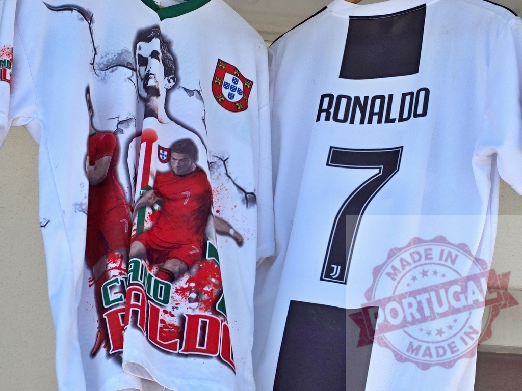 Cristiano Ronaldo football jerseys hanging representing Portugal and Juventus | Cristiano Ronaldo jerseys displaying Portugal national team and Juventus club colors and branding - Realisiert mit Pictrs.com
