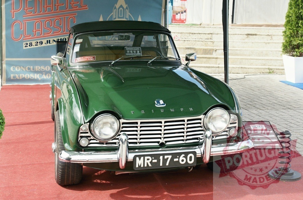 Triumph TR4 classic car at Penafiel Classic exhibition | Triumph TR4 vintage convertible displayed on a red carpet at Penafiel Classic event - Realized with Pictrs.com