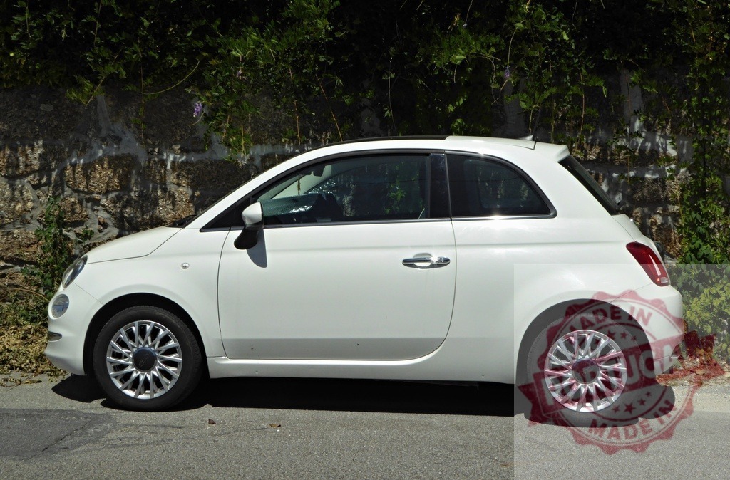 White Fiat 500 car parked alongside stone wall | White Fiat 500 compact car parked on a sunny day - Realized with Pictrs.com