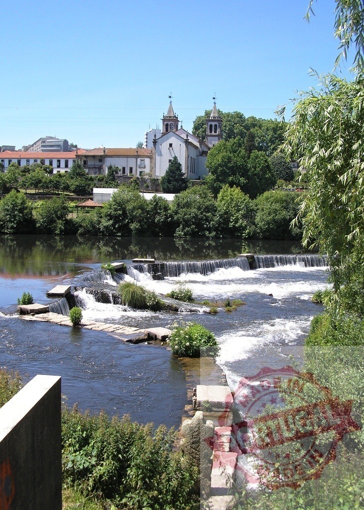 Vez River rapids and church in Arcos de Valdevez, Portugal. Norte - Portugal | Vez River flowing through Arcos de Valdevez village with stepping stones and historic church - Realized with Pictrs.com