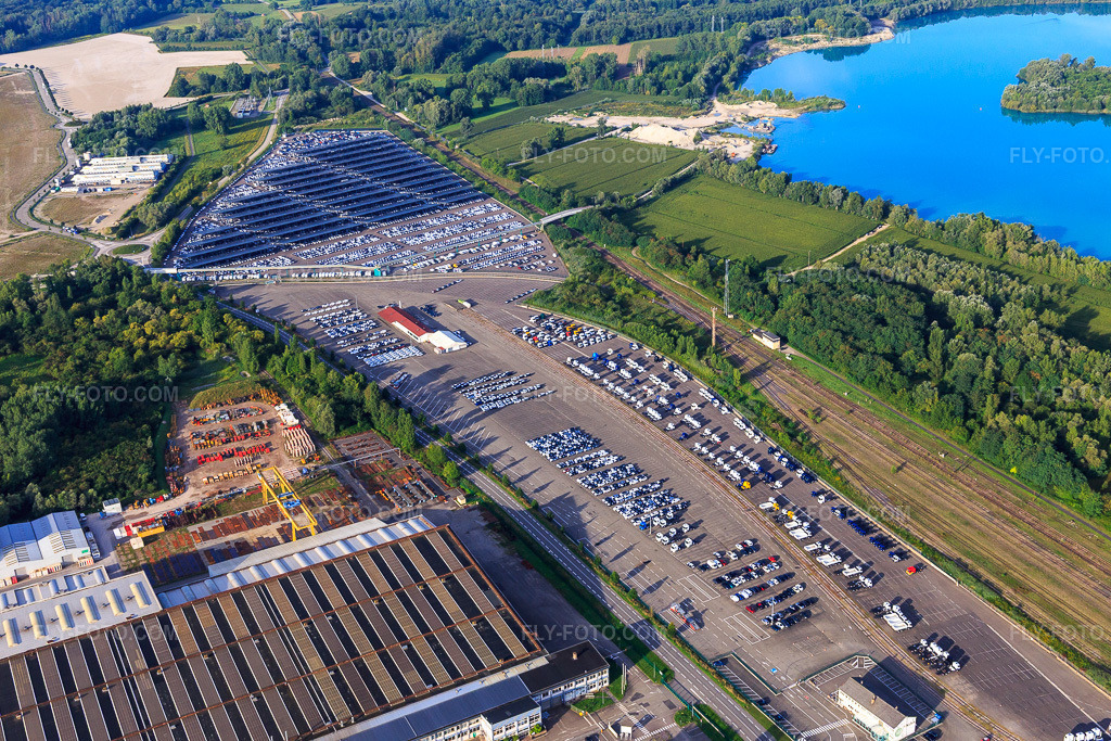 Aerial view: ARCHICUB - Parking area for the import of trucks and cars by Walon in Lauterbourg in the state Bas-Rhin, France. – Photo: IMG_149484.jpg taken on 08/09/2025 by Werner Riehm/FLY-FOTO.com – Resolution of the original: 5472 x 3648 px – Solutions logistiques pour l'industrie: