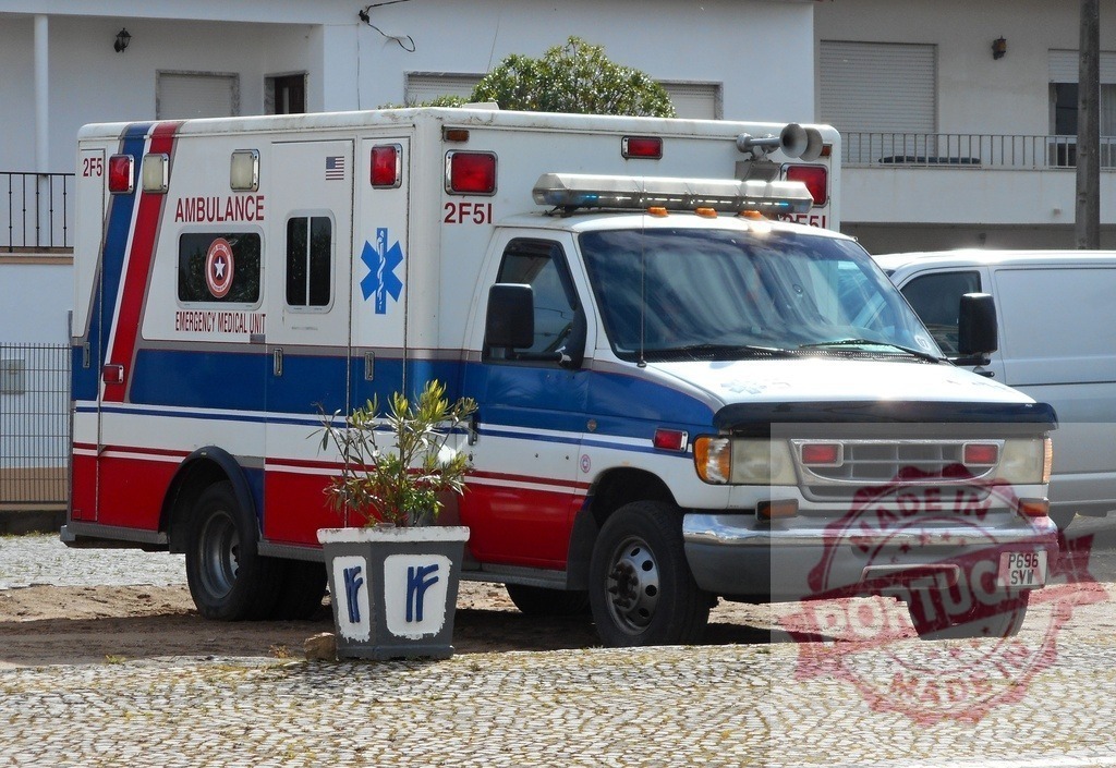 Ambulance parked on cobbled street, emergency medical unit | Ambulance standing on a textured cobblestone surface, representing emergency services and medical transport - Realized with Pictrs.com