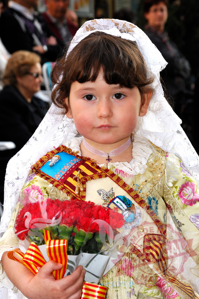 Young girl celebrating Fallas festival in Valencia Spain | Little girl in traditional Valencian Fallera costume holding red carnations for the offering - Realized with Pictrs.com