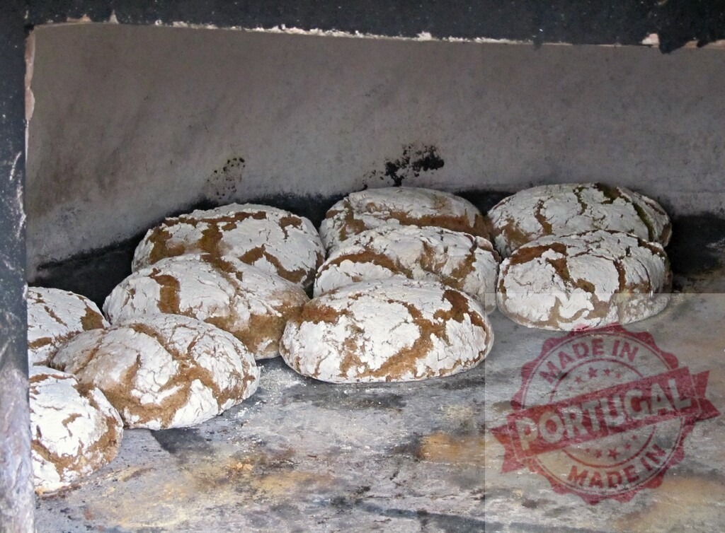 Fresh bread loaves baking in traditional bread oven | Rustic sourdough bread loaves baking inside a hot, wood-fired oven - Realized with Pictrs.com