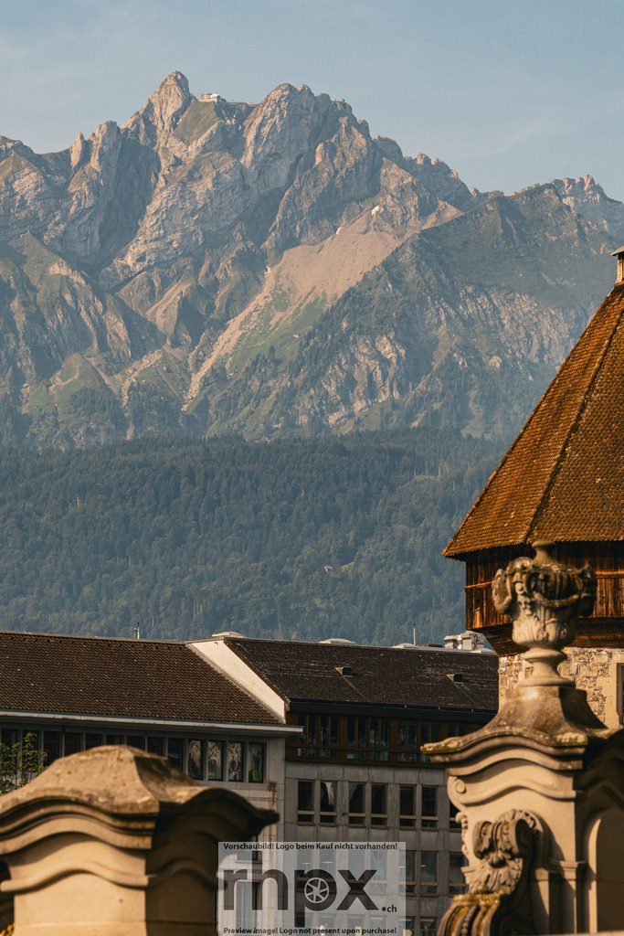 Pilatus über den Dächern von Luzern mit Wasserturm | Dach. Wasserturm. Felswand.Ein Bild, das die Nähe von städtischer Kultur und alpiner Wildnis eindrucksvoll zeigt.Wähle unter "Produktauswahl" dein Wunschformat: Vom klassischen Wandbild über Puzzle &amp; Tassen bis zum digitalen Download (z.B. als Handy-Hintergrund). - Realisiert mit Pictrs.com