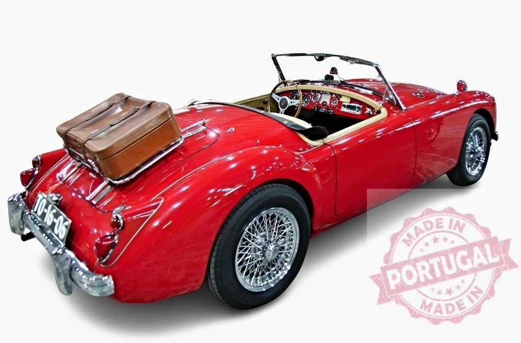 Classic MG A Roadster sports car parking with luggage for a road trip | Red MG A Roadster sports car parking with luggage on the back ready for a road trip adventure - Realized with Pictrs.com