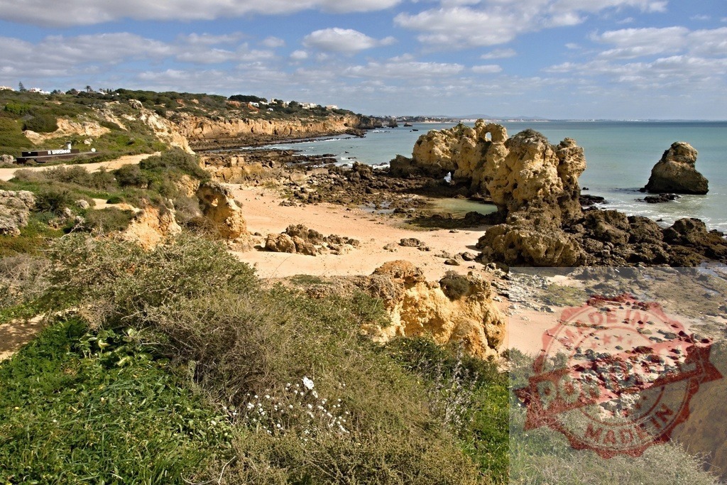 Algarve coast displaying scenic rugged cliffs and rock formations | Algarve coast featuring sand, ocean, and natural rock formations under a cloudy sky - Realized with Pictrs.com