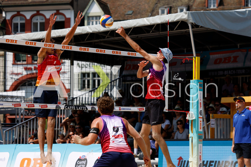 Obi BeachTour 2026 - Basel | BASEL, SWITZERLAND - JULY 19: SIMON HAGENBUCH (SUI) attack / spike against LUC EMANUEL FLÜCKIGER (SUI) block during the Obi BeachTour 2026 match between DILLIER / FLÜCKIGER (SUI) and HAGENBUCH / HAUSSENER (SUI) at Barfüsserplatz on July 19, 2026 in Basel, Switzerland. - Realisiert mit Pictrs.com