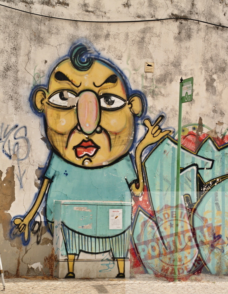 Funny cartoon character graffiti making rock and roll gesture on weathered urban wall | Whimsical graffiti art of a cartoon character making a rock and roll hand sign adds a touch of humor to a weathered urban wall - Realized with Pictrs.com