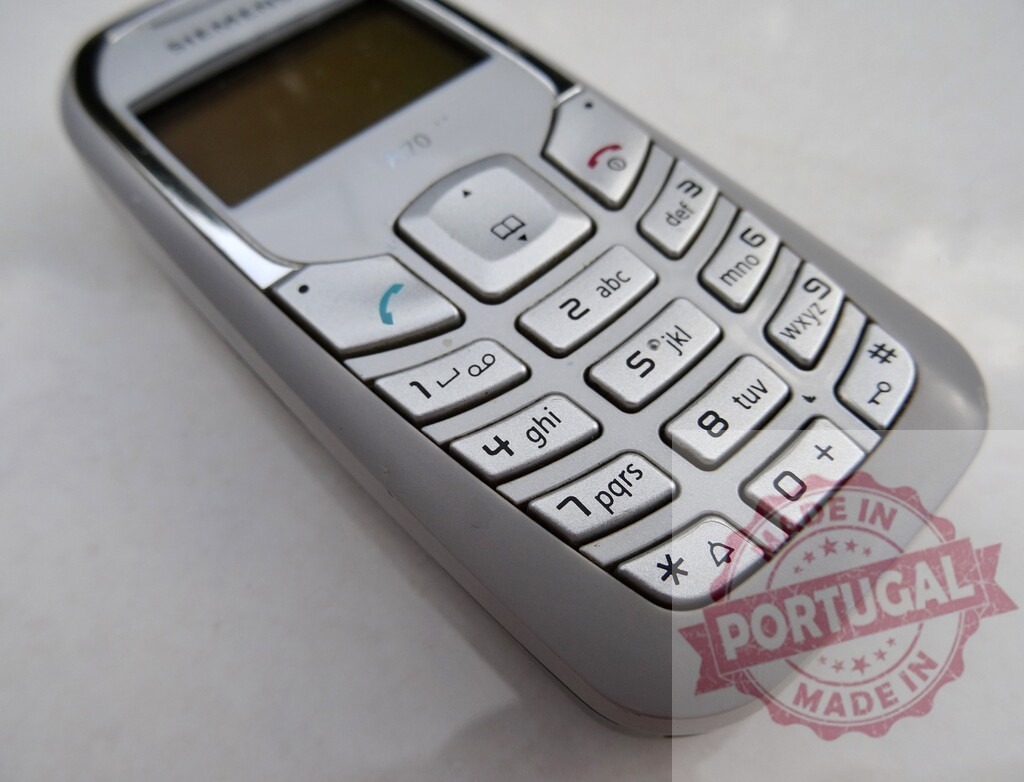 Siemens A70 mobile phone showing keypad and screen on white background | Old Siemens A70 mobile phone showing keypad and screen on white background, featuring number keys, call and end call buttons, and navigation keys - Realized with Pictrs.com