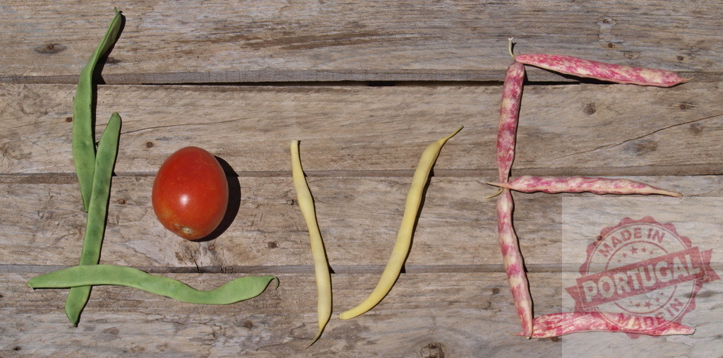 Love word spelled with vegetables on rustic wood | Word love spelled out using green beans, yellow beans, pinto beans, and tomato on wooden background - Realized with Pictrs.com