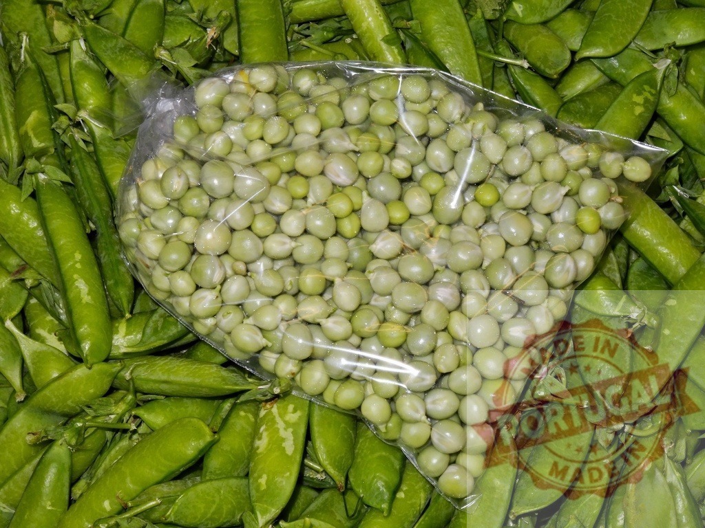 Fresh green peas in plastic bag on pods | Fresh green peas packed in a plastic bag lying on a large pile of pea pods - Realized with Pictrs.com