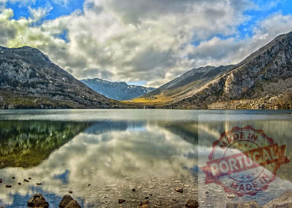 Beautiful mountain lake reflecting clouds and blue sky in Picos de Europa | Mountain lake reflecting the sky with clouds in Picos de Europa National Park, Spain - Realized with Pictrs.com
