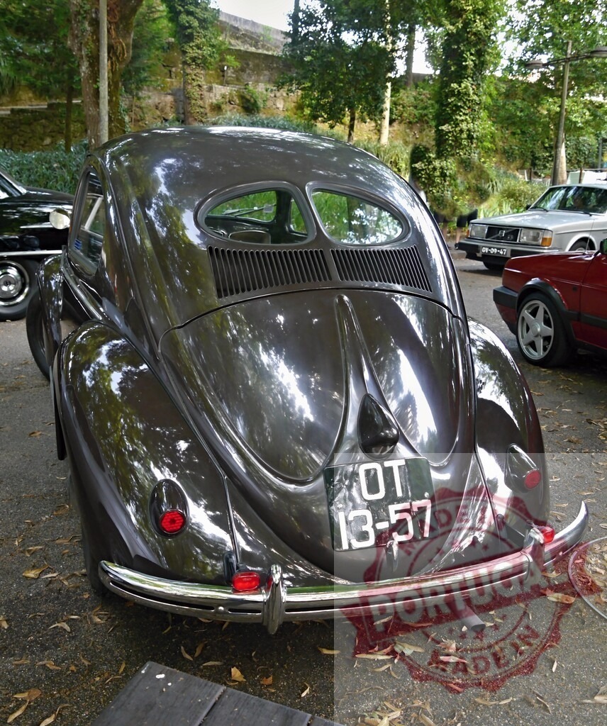 Volkswagen Beetle black split-window classic car rear view | Vintage Volkswagen Beetle with split rear window parked outdoors - Realized with Pictrs.com