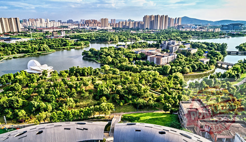 Urban development surrounding a large city park with lakes | Panoramic aerial view showing a modern Chinese urban landscape integrating green areas and water features - Realized with Pictrs.com