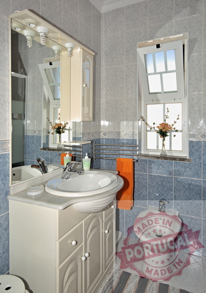 Modern bathroom interior featuring sink bidet and window | Clean bathroom interior showcasing a white sink, bidet, vanity, mirror, and window - Realisiert mit Pictrs.com