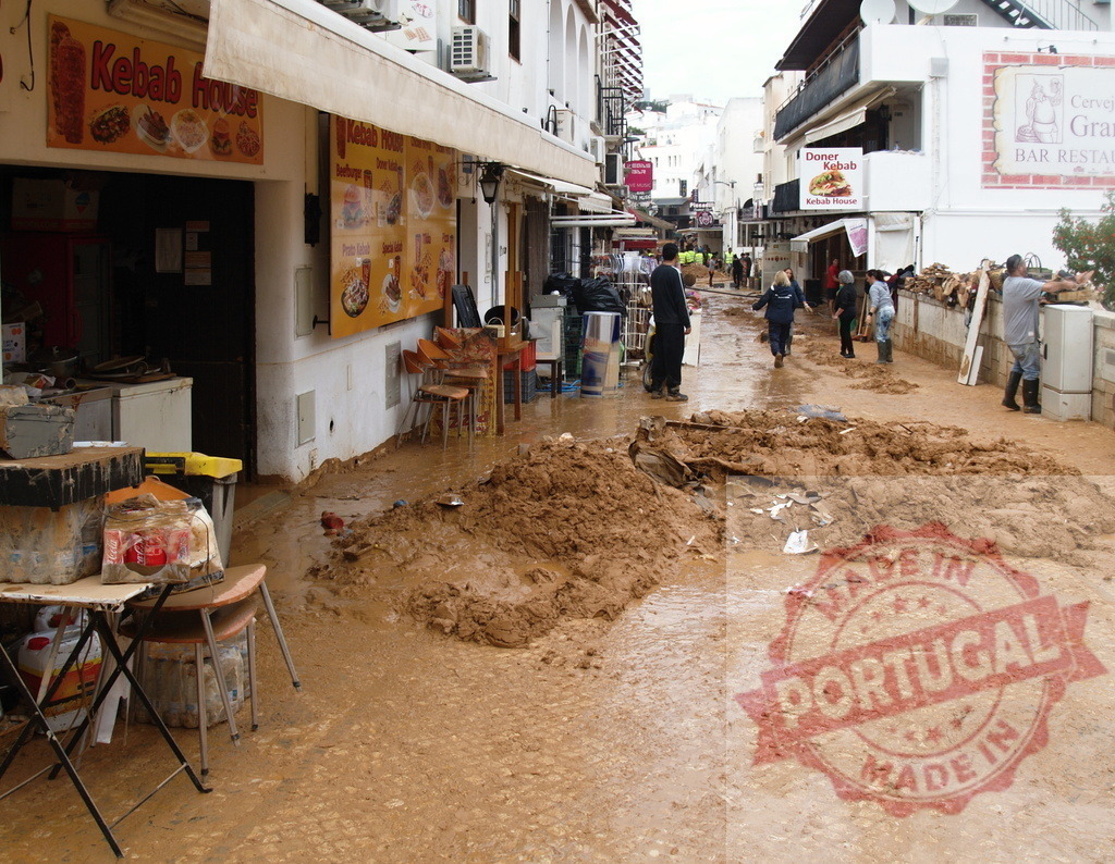Street cleaning following severe flood and mud disaster | Albufeira Flood - discruction by weather problems People cleaning muddy street and damaged businesses after a natural disaster - Realized with Pictrs.com
