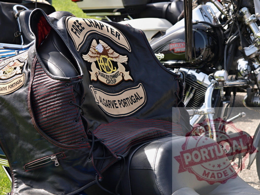 Harley Owners Group Algarve Portugal vest on motorcycle | Harley Owners Group Free Chapter leather vest resting on a Harley-Davidson motorcycle seat - Realized with Pictrs.com
