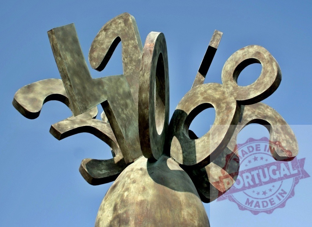 Abstract bronze sculpture creating modern art and symbols. Provincia de Castellon | Abstract bronze sculpture with numerical shapes under a clear blue sky, evoking creativity - Realized with Pictrs.com