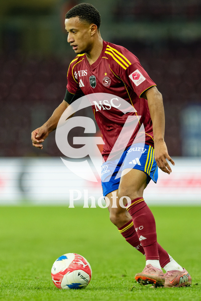 Brack Super League - Servette FC v FC Lausanne-Sport | Lilian Njoh (14 Servette FC) controls the ball (action)  during the Brack Super League match between Servette FC and FC Lausanne-Sport at Stade de Geneve in Geneva, Switzerland