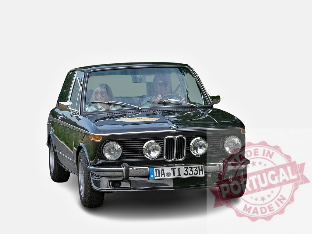 Senior couple driving vintage BMW 1602 on white background | Front view of vintage black BMW 1602 with senior couple driving - Realized with Pictrs.com