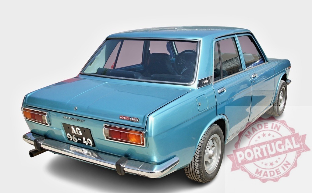 Blue Datsun 1600 SSS classic car rear view | Blue Datsun 1600 SSS vintage sedan displaying classic automotive design on white background - Realized with Pictrs.com