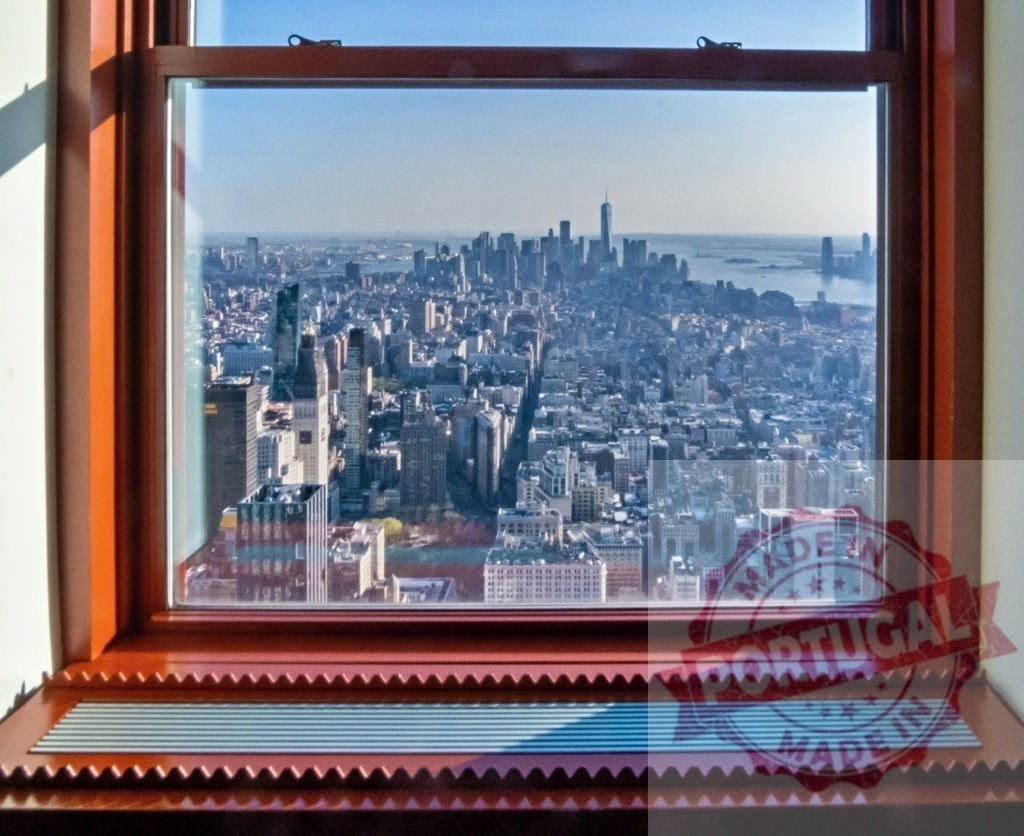 Empire State Building framing New York City skyline through window | New York City skyline featuring One World Trade Center, seen through Empire State Building window - Realized with Pictrs.com