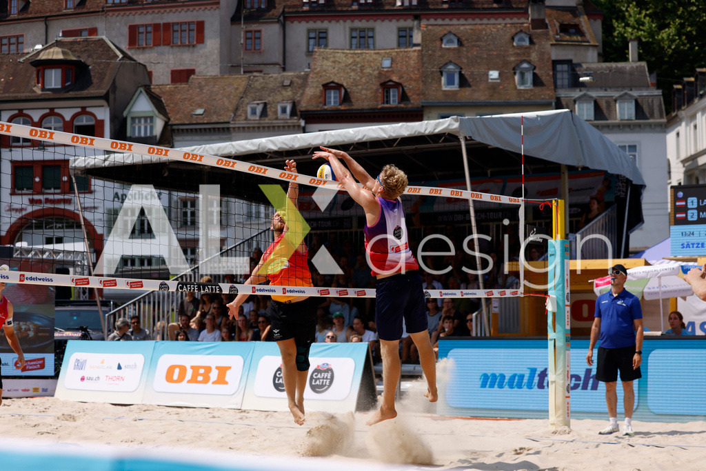Obi BeachTour 2026 - Basel | BASEL, SWITZERLAND - JULY 19: MORITZ KINDL (AUT) attack / spike against MATHIS KÄLIN (SUI) block during the Obi BeachTour 2026 match between LEITNER / KINDL (AUT) and BREER / KÄLIN (SUI) at Barfüsserplatz on July 19, 2026 in Basel, Switzerland. - Realisiert mit Pictrs.com