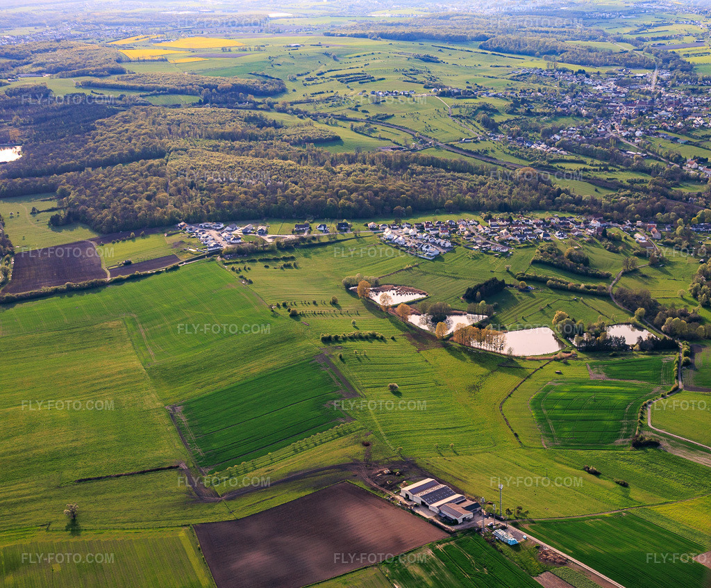 Aerial view: Four ponds on Rue Des ètangs in Metzing in the state Moselle, France. – Photo: IMG_154644.jpg taken on 04/17/2026 by Werner Riehm/FLY-FOTO.com – Resolution of the original: 4484 x 3704 px