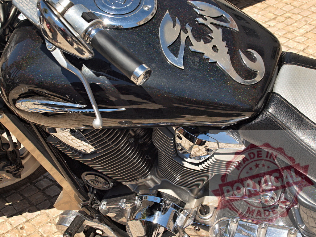 Custom black motorcycle fuel tank with scorpion emblem | Black motorcycle fuel tank featuring a chrome scorpion emblem, handlebars, and shiny engine details - Realized with Pictrs.com
