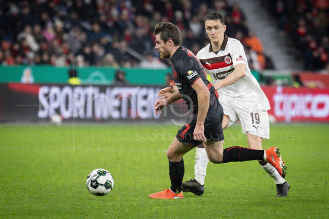 Bayer 04 Leverkusen vs. FC St. Pauli, 03.02.2026 | LEVERKUSEN, GERMANY - FEBRUARY 3:  Martijn Kaars (FC St. Pauli, 19) can’t stop Jonas Hofmann (Bayer 04 Leverkusen, 7) during the DFB Cup quarter-final match Bayer 04 Leverkusen vs. FC St. Pauli at BayArena on February 3, 2026 in Leverkusen, Germany. (Photo by Axel Kohring/Beautiful Sports Int.)DFL REGULATIONS PROHIBIT ANY USE OF PHOTOGRAPHS AS IMAGE SEQUENCES AND/OR QUASI-VIDEO.