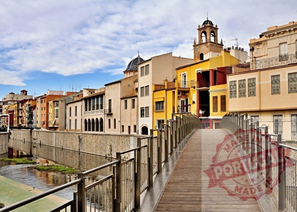 Girona Onyar River colorful houses and bridge spanning | Girona city view showing colorful houses lining the Onyar River with a modern bridge - Realized with Pictrs.com