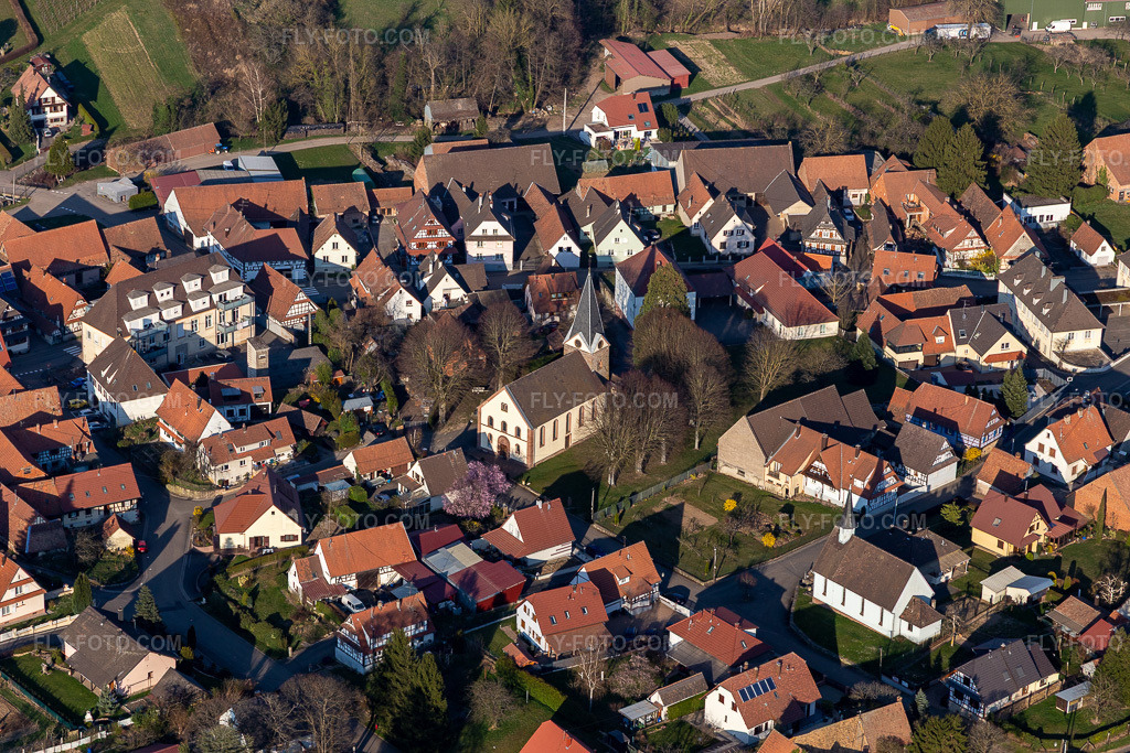 Aerial view: Temple Protestant Saint Laurent in Steinseltz in the state Bas-Rhin, France. – Photo: IMG_130949.jpg taken on 03/22/2022 by Werner Riehm/FLY-FOTO.com – Resolution of the original: 5472 x 3648 px