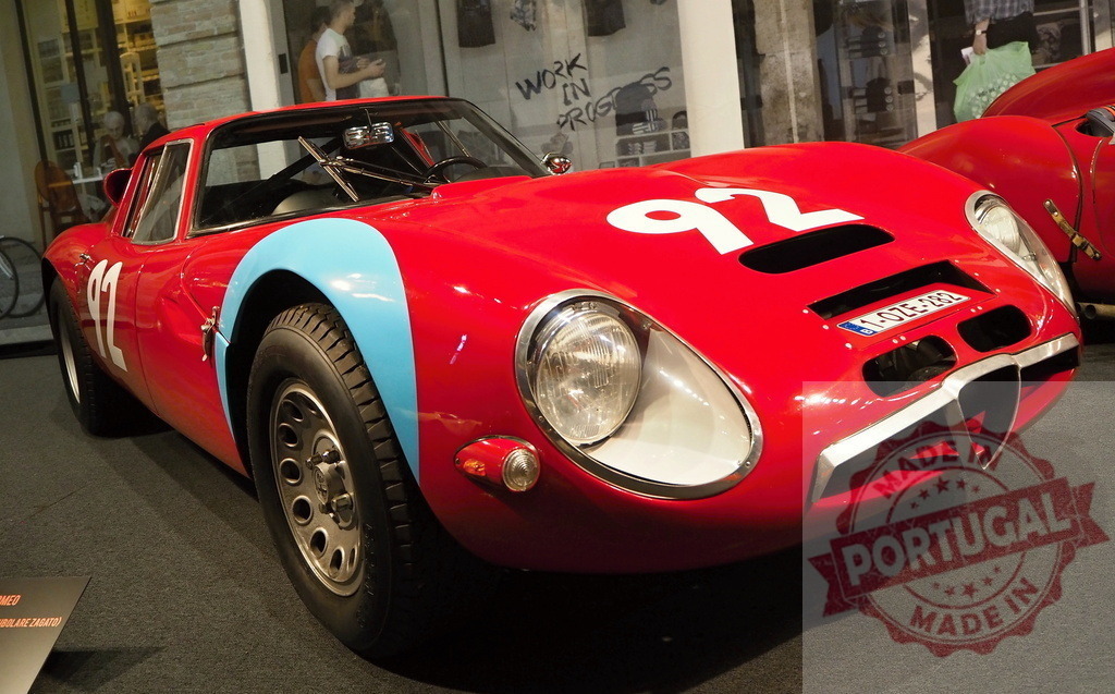 Alfa Romeo Giulia TZ vintage race car | Red classic sports car with number 92 on display at an exhibition - Realized with Pictrs.com
