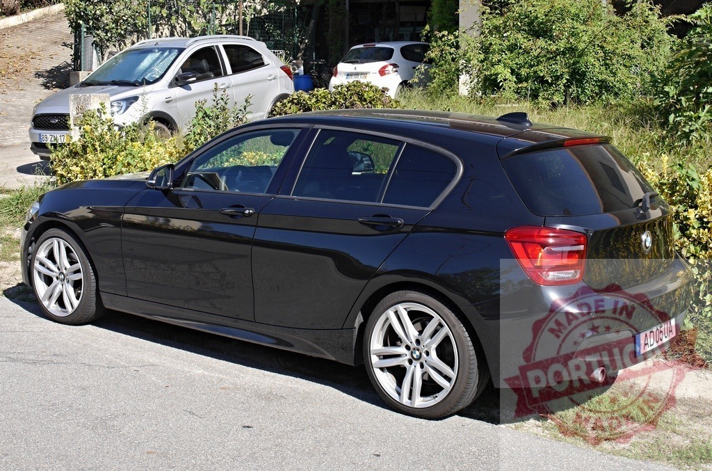 BMW 1 Series M Sport parked on street | Black BMW 1 Series hatchback parked outdoors on a public street - Realized with Pictrs.com